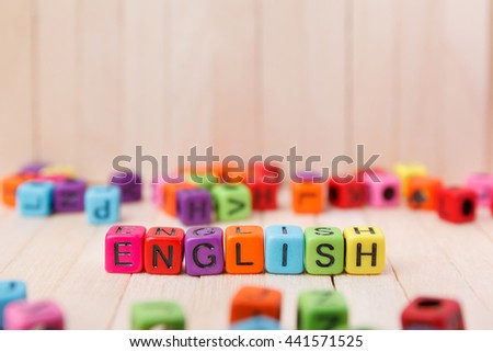 Colorful of word block cube with english text on wooden top table, english language learning concept 