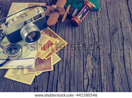 image of Retro camera and vary of decoration on wood table background(vintage color tone)