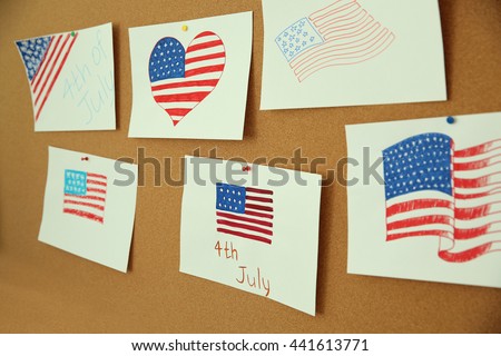 Child's drawings of American flag on cork board