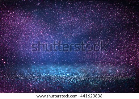 glitter vintage lights background. blue, purple and black. defocused.
