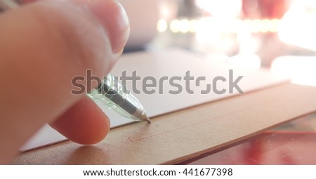 Focus left hand signing a contract