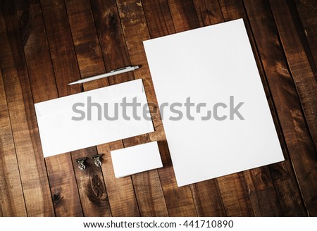 Blank stationery set. Blank corporate identity template on vintage wooden table background. Blank letterhead, business cards, envelope and pen. Mock-up for branding identity.