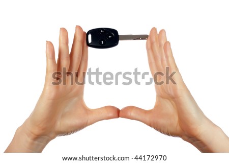 Hands holding an automobile key isolated on white