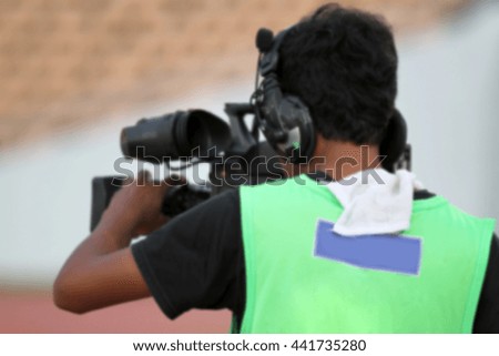 blurry of Professional cameraman and Video camera operator working with his professional equipment