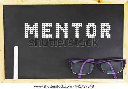 MENTOR word in blackboard with chalk and glasses