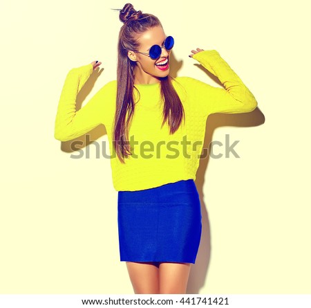 portrait of cheerful fashion hipster girl going crazy  in casual colorful hipster yellow summer clothes with red lips isolated on white Royalty-Free Stock Photo #441741421