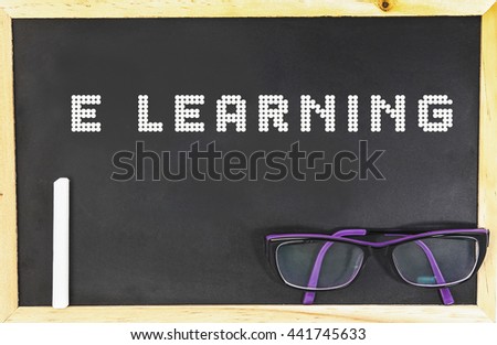 E - LEARNING word in blackboard with chalk and glasses