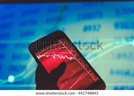 Device on hand to check stocks and market data. Market graph with arrows tending.Digital Marketing Graph Statistics Analysis Finance Market Concept. Marketing Analysis Accounting from digital chart.