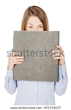 woman holding a gray folder and hiding her face. Isolated on white background. emotions, facial expressions, feelings, body language, signs. image on a black studio background.