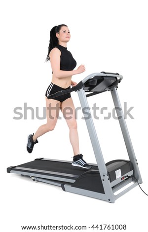 young woman running on treadmill machine, motion blur, isolated at white background