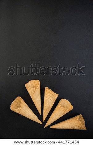 top view of Wafer cups for ice-cream on black slate table