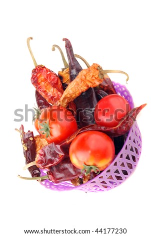 Bitter pepper of red colour and tomatoes on a white background