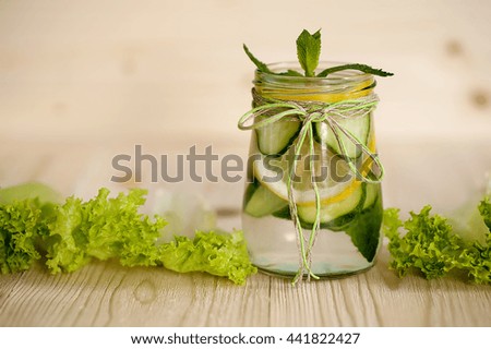 Infused water with mint, lemon and cucumber  in a glass.