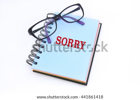 SORRY word in notepad with white background