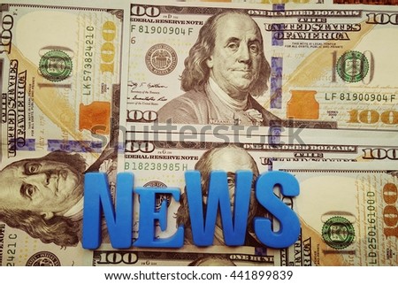 News concept. Blue letters on a background of US dollars