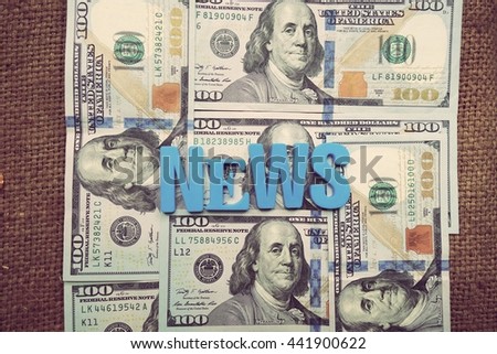 News concept. Blue letters on a background of US dollars