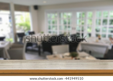 Empty brown wooden table and blur background of abstract blurred background of resturant lights ,for product display montage,can be used for montage or display your products

