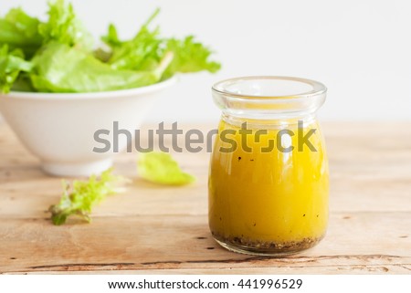 bottle of homemade basic salad dressing made with olive oil lemon juice honey salt and black pepper
 Royalty-Free Stock Photo #441996529