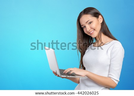portrait of beautiful young woman holding laptop isolated 