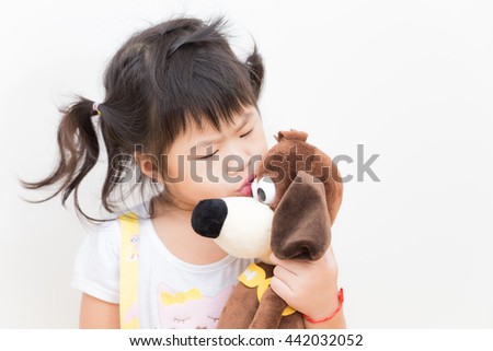 How are you my doll, Pretty smiling girl playing with lovely dog doll on white background