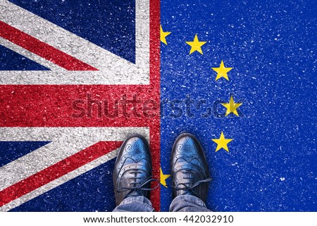 Brexit, flags of the United Kingdom and the European Union on asphalt road with legs Royalty-Free Stock Photo #442032910