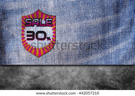Sale, discount labels. 30% off on blue denim jeans background.