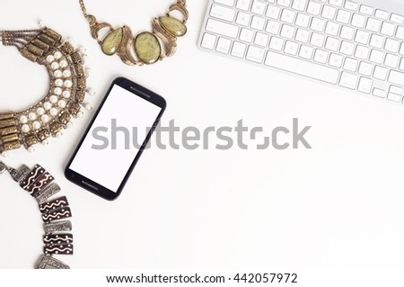 Table top view of Indian handicraft jewelery with computer keyboard and mobile phone for on line shopping
 Royalty-Free Stock Photo #442057972