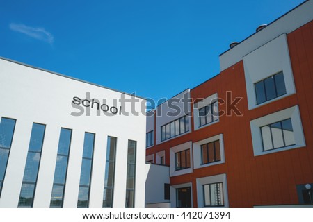 Modern school building. Sunny day, blue sky. Royalty-Free Stock Photo #442071394