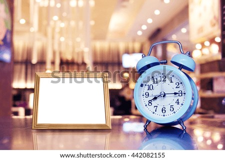 Alarm clock and photo frames on the table  - Vintage effect background