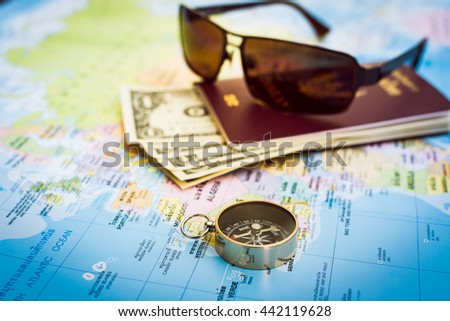 Travel concept, Compass, passport, money and sunglasses on the map
