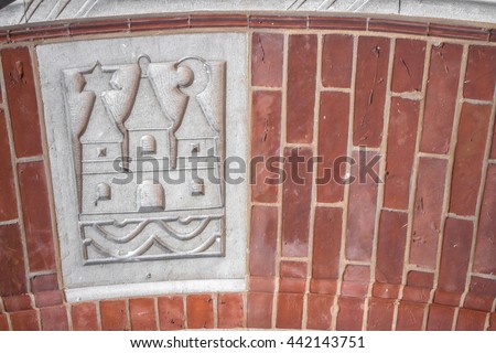 Coat of arms, Copenhagen, Denmark. Three towers rising above water. The left and right towers represented Absalon's castle. Space for your own text. Carvings sign of Copenhagen on brick stone wall. 