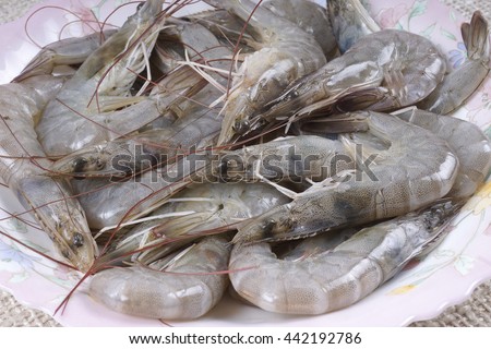 Raw black tiger shrimp isolated on wooden background
