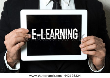 Business man holding tablet with the text: E-Learning