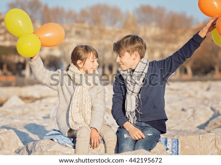 Happy kids with baloons outdoors
