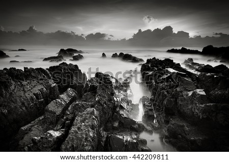 Tropical rocky beach at sunrise in black and white (nature landscape)
long exposure photography 