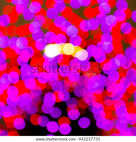 Abstract blurred color bokeh lights on black background