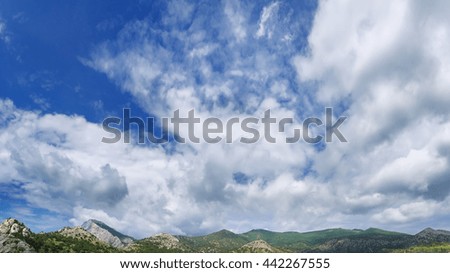 clouds over mountain peaks / photo bright summer day city Sudak