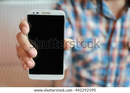 man show his smart phone, young man using mobile smart phone, Internet of things lifestyle with wireless communication and internet with smartphone.
