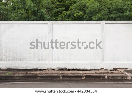 Street sidewalk and white wall.