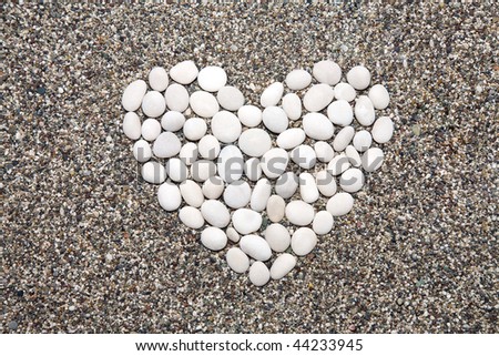 Heart collected from sea a pebble on sand