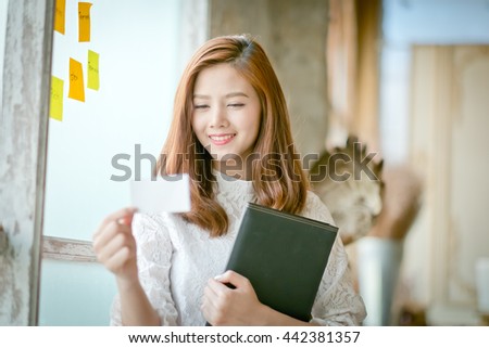 Beautiful businesswoman with smile,showing blank name card