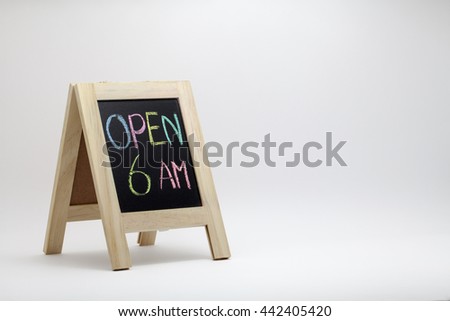 wording 'Open 6 AM' sign concept with small blackboard on white gradient background. colorful chalk.Text space on right screen for web template or presentation or business marketing.