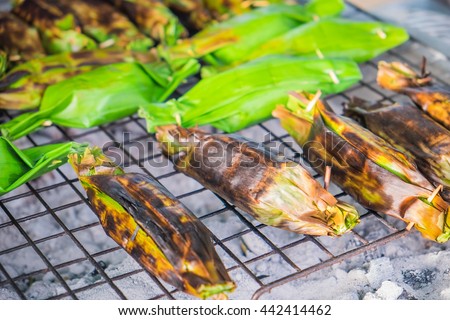 Delicious popular traditional Thai Asian style dessert food. Sticky rice toast with taro and banana leaf in Bang Nam Phueng Floating Market, Samut Prakan province, Thailand.