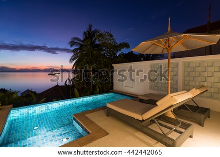 Swimming pool with sunset view at Regent Phuket Cape Panwa, Phuket, Thailand. Royalty-Free Stock Photo #442442065