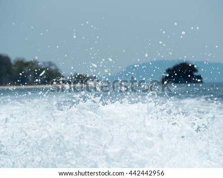 Unique sea water foam against sea and Island in background. Summer and travel concept.