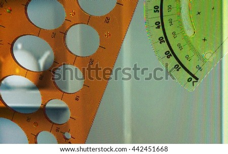 Green protractor and circle template on home picture  background