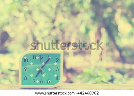 blue alarm clock on bokeh background,Close up blue alarm clock,vintage tone