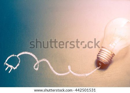 Light bulb and chalk drawing on blackboard