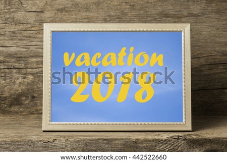 phrase the Vacation of 2018 in a wooden photo frame