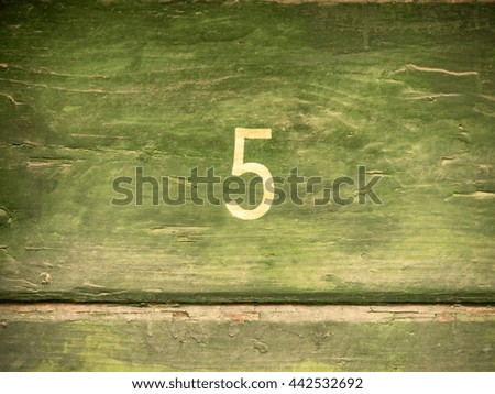 number 5 on wooden wall